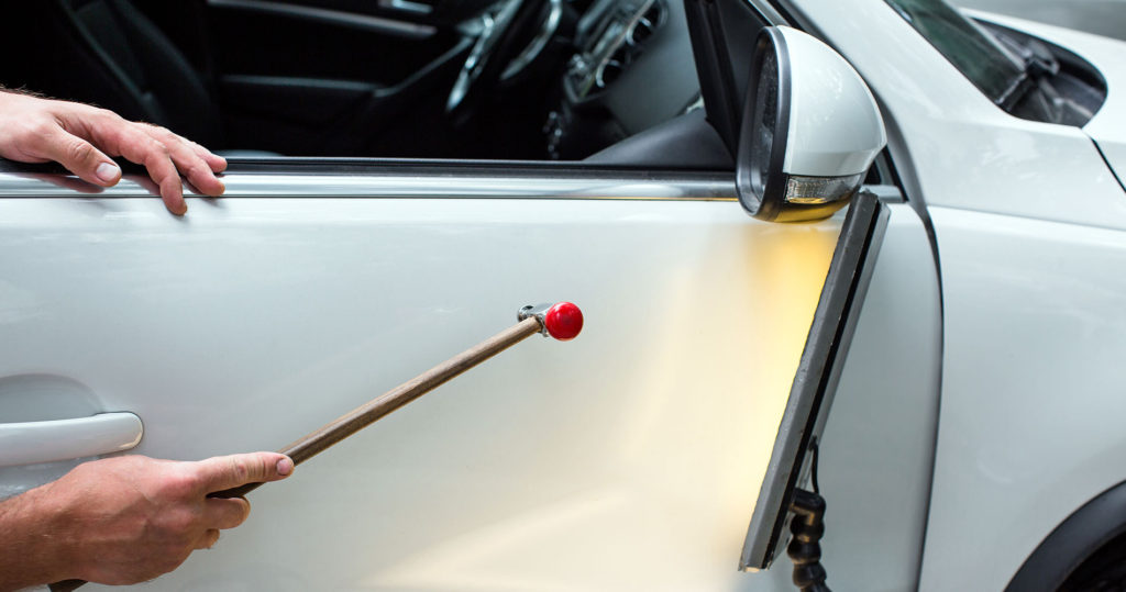 image of person performing paintless dent repair