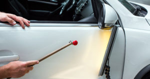 image of person performing paintless dent repair